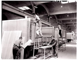 "Johannesburg, 1962. Sheetmetal workers fitting cladding on trailers in SAR Road Transport S...