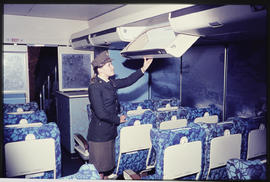 SAR policewoman checking interior of aircraft.
