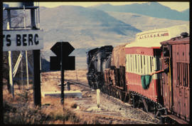 Graaff-Reinet district. SAR Class GMA steam locomotive arriving with mixed train on top of Lootsb...