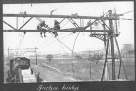 Circa 1925. Men working on anchor bridge . (Album on Natal electrification)