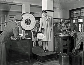 Johannesburg, 1945. Rand airport. Lady passenger being weighed on scale. 56 kilograms = 123 pounds.