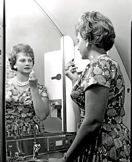 
SAA Boeing 707 interior, woman refreshnig makeup.
