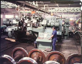 Fitter and turner in large workshop.