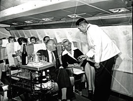 
SAA Boeing 707 ZS-CKC interior. Steward serving passengers.
