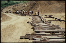 Damaged bridge over wide river.