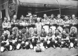 
Steam Sheds rugby team with locomotive foreman Moore before locomotive.
