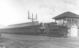 Cape Town. SAR Class 03 'Wynberg Tender' engine passing Tennant Street locomotive depot and signa...