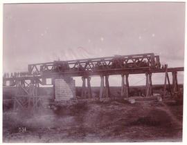 Circa 1900. Anglo-Boer War. Vet River high level bridge, troops drawing girder out.