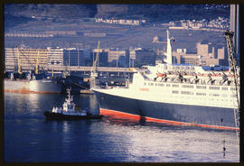 Cape Town, 1985. SAR tug with 'Queen Elizabeth 2' in Table Bay Harbour. [JV Gilroy]