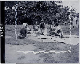 
Group of Zulu women sitting on grass.
