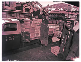 Cape Town, 1950. Loading boxes onto SAR truck No B3127 in railways goods yard.