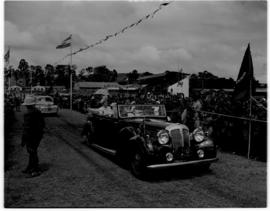 Pretoria, 29 March 1947. Royal family in open car greeted by crowd as they enter a stadium.