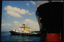 Richards Bay, 1991. SAR tug with ship in Richards Bay Harbour.