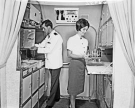 
Steward and hostess at work in galley of SAA Boeing 727.
