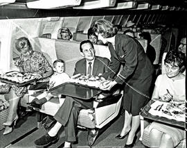 
SAA Boeing 707 ZS-CKC interior. Hostess serving passengers.
