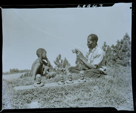 Zululand, 1961. Zulu sculptor Ntuli modelling figurines.