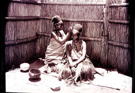 Swaziland, 1933. Swazi women dressing hair.