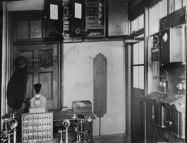 Circa 1920. Interior of train control office with selector hones and instruments.