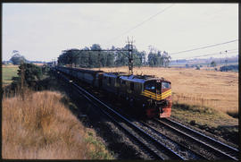 Durban district, July 1986. SAR Class 6E1 No E2021 with passenger train near Hammarsdale. [Z Craf...