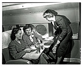 
SAA Lockheed Constellation interior. Hostess serving lunch.
