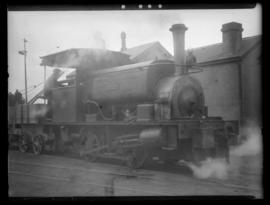 Shunting harbour engine 'Thebus' in steam and portion of bogie wagon just visible. Built by Hudwe...