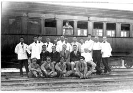 
Train staff posing with dining car. Photographs taken during Round-in-Nine tour.
