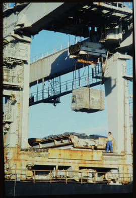 Lifting large granite block with overhead crane.