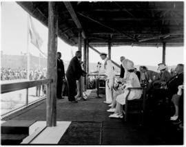 King William's Town, 4 March 1947. Royal Family on dais, Chief Archie Sandile handing King George...