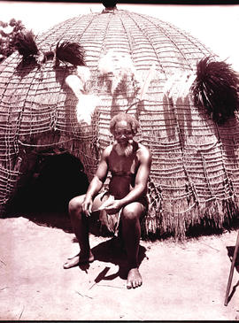Swaziland, 1933. Elderly Swazi man in front of hut.