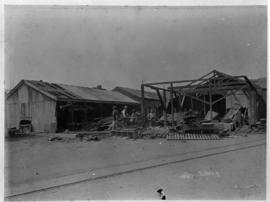 Durban, circa 1901. Corrugated iron building being demolished. (Durban Harbour album of CBP Lewis)
