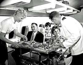 
SAA Boeing 707 interior. Snacks being served. Steward and hostess.
