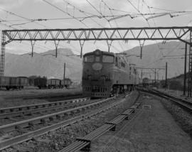 De Doorns, 1970. SAR Class 5E1 with the Trans-Karoo approaching the railway station from the Ospl...