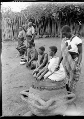 Louis Trichardt district, 1934. Venda family next to traditional drum.