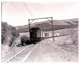 Volksrust district, 1940. Two SAR Class 1E's with goods train in the Drakensberg area.