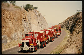 
Four SAR International Pacific trucks with heavy beam in long road cutting.
