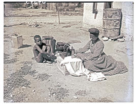Windhoek, Namibia, 1952. Herero woman sewing clothes.