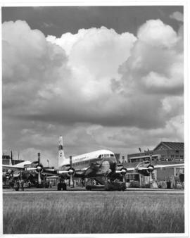Johannesburg. Jan Smuts airport. SAA Douglas DC-7B ZS-DKD Dromedaris and behind it an SAA Douglas...