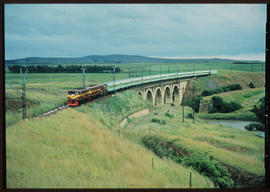 Two electrical locomotives with 'Drakensberg' on concrete arch bridge.