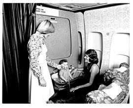 
Cabin service in SAA Boeing 747, hostess with baby in bassinet.
