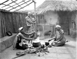Tzaneen district, 1951. Preparing food at a traditional hut.
