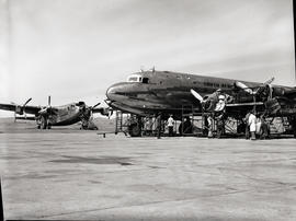 
SAA Douglas DC-4 ZS-BMG 'Magaliesberg' undergoing maintenance. In the background is BOAC Avro Yo...
