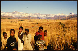 Group of children with snow-clad Drakensberg in the distance.