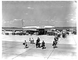 
SAA Boeing 707 ZS-CKE 'Durban' on apron. Passengers walking away from aircraft.
