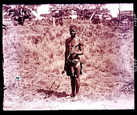 Masvingo district, Rhodesia. Man with knob kierie and assegai at Great Zimbabwe.