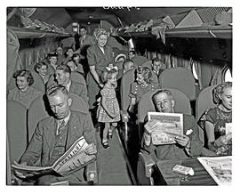 
SAA Douglas DC-4 interior filled with passengers.
