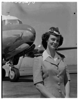 September 1952. Miss Badenhorst, air hostess, at nose of SAA Douglas DC-4 Skymaster.