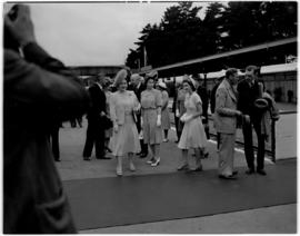 
Royal family and dignitaries on station platform.
