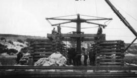 Wilderness, circa 1926. Duive River bridge construction: Pile screwing from sleeper cribs. (Colle...