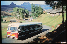 Drakensberg, 1984. SAR Leyland Olympic tour bus No MT16937 with Amphitheatre in the distance.