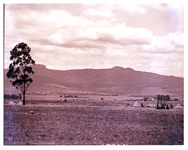 "Louis Trichardt, 1960. Traditional huts with town in the distance."